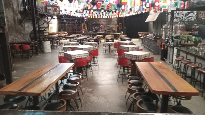 Long tables and bar seating arranged for guests at Red Macaw